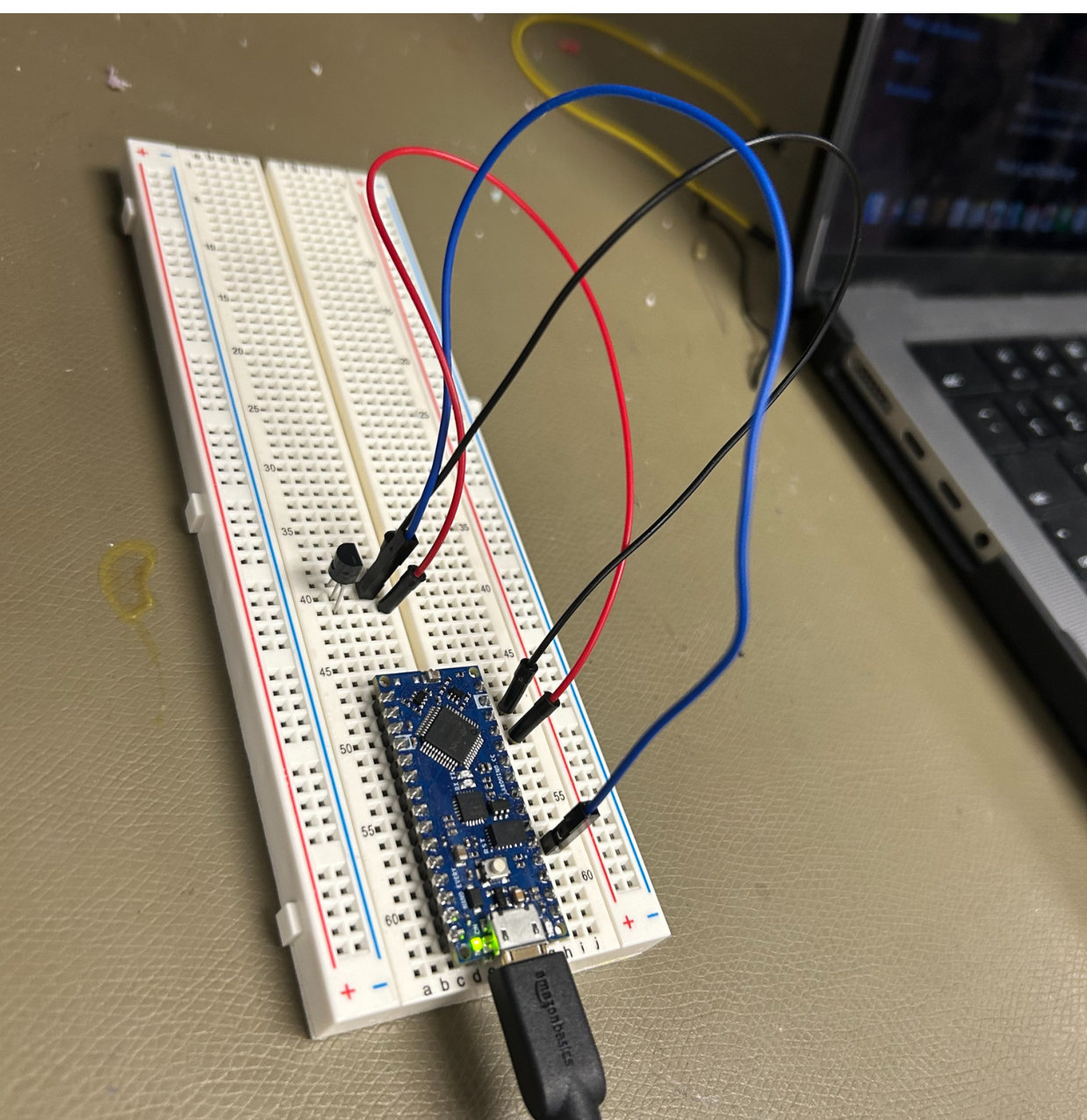 Arduino Nano on a breadboard wired to a three-pin temperature sensor